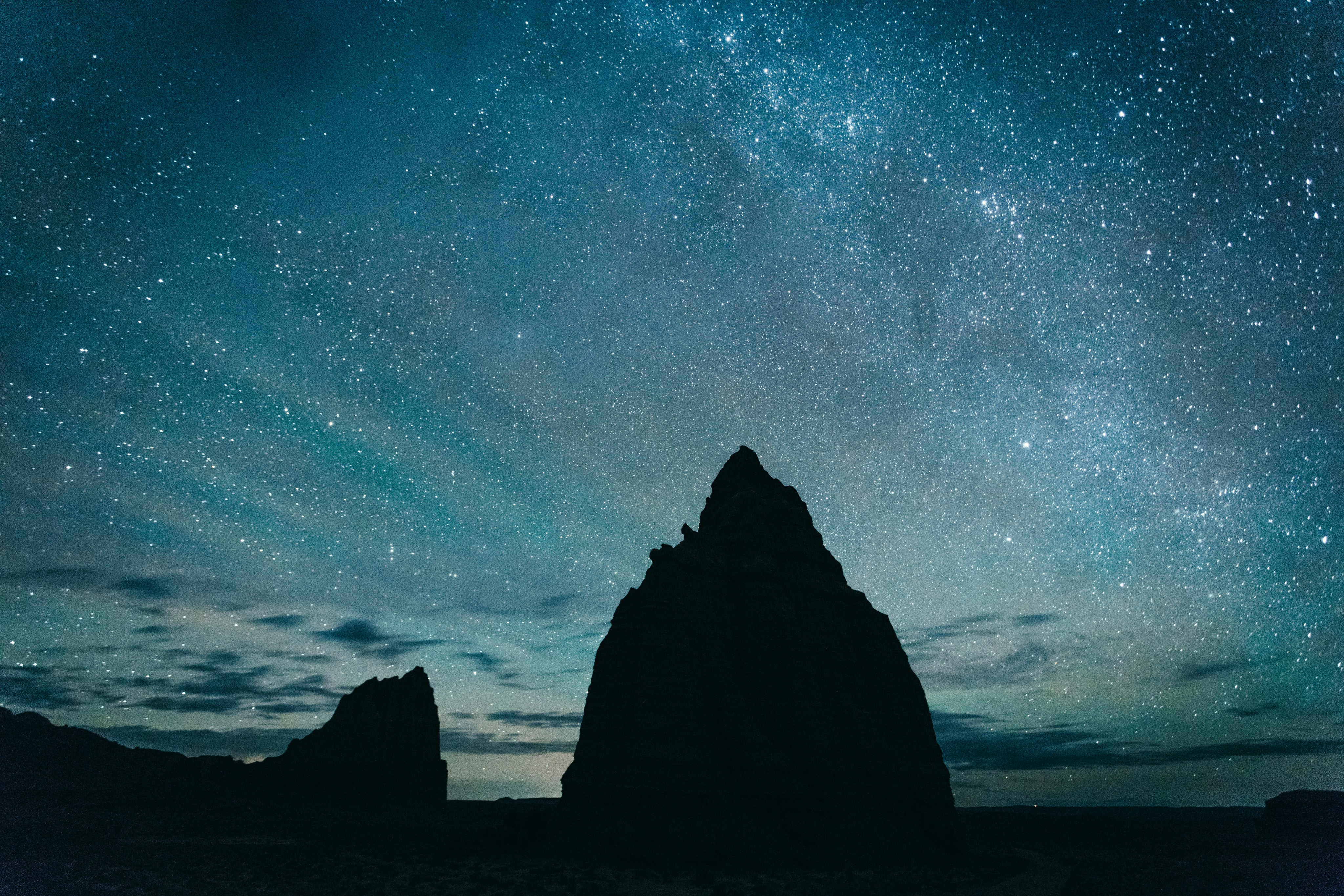 silhouette of rocky mountain under starry sky